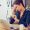 Frustrated young woman keeping eyes closed and massaging nose while sitting at her working place in office